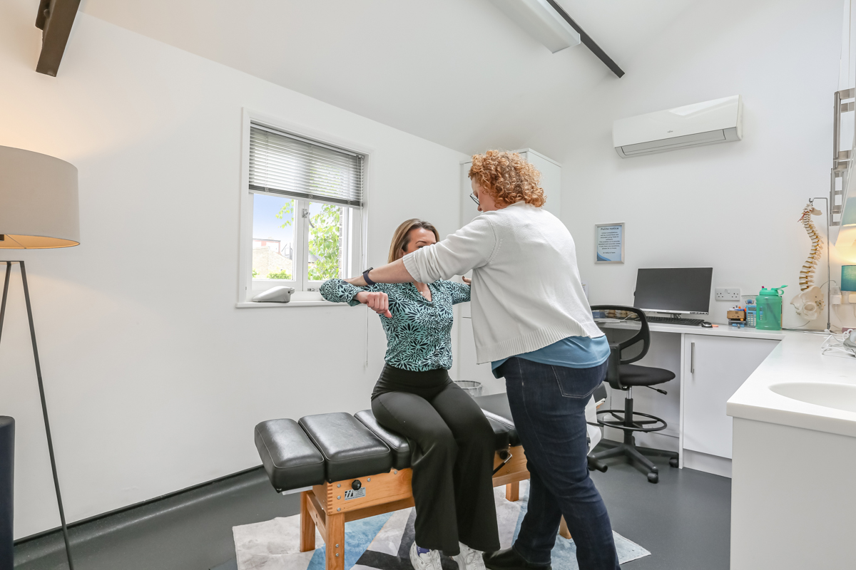 Kelly assessing a patient at Kingston Chiropractic & Wellness Centre