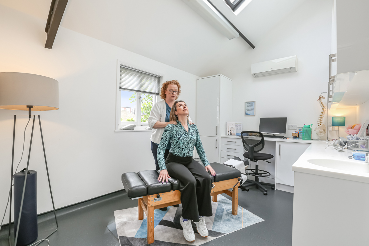 Kelly providing chiropractic neck treatment at Kingston Chiropractic & Wellness Centre